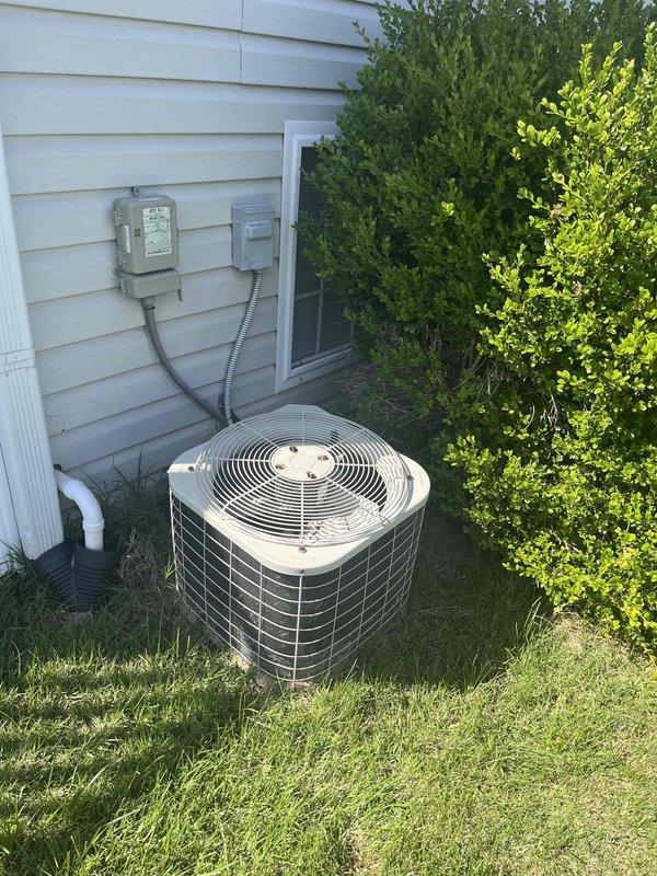Conducted comprehensive replacement estimate for 27-year-old original HVAC system with uncertain operational status. Evaluated existing outdoor condenser unit positioned on concrete pad near residential structure, assessed electrical disconnect and meter configuration, and documented gas meter assembly for system compatibility requirements. Provided homeowner with complete replacement options and specifications for aging equipment approaching end of service life.