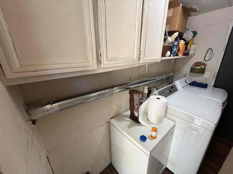 Installed new exterior dryer vent termination on building exterior wall with brown louvered vent cover, properly secured to vinyl siding. Routed and connected metallic ductwork from laundry room dryer to exterior termination point, ensuring proper airflow and code-compliant installation.