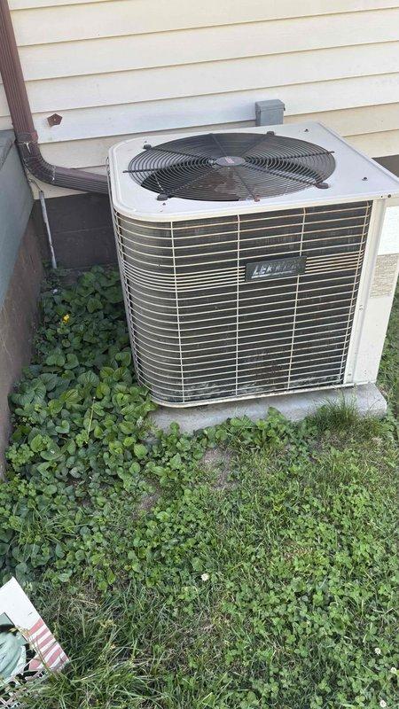 Conducted comprehensive replacement estimate for residential HVAC system including outdoor condenser unit and indoor Bryant furnace with integrated cooling components. Evaluated existing equipment condition, noting outdoor unit positioned on concrete pad with vegetation encroachment and indoor furnace installation in confined mechanical closet with PVC venting system and copper refrigerant lines. Documented system configuration, measured equipment dimensions, assessed electrical disconnect and ductwork connections, photographed current installation for replacement specifications, and provided homeowner with complete system replacement options during consultation.