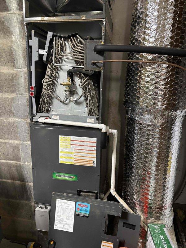 Completed annual Gold Level planned maintenance on 6-year-old residential HVAC system. Performed comprehensive inspection of furnace and evaporator coil assembly, removing upper access panel to examine internal heat exchanger components and refrigerant line connections. Assessed blower motor housing and centrifugal fan wheel, noting moderate dust accumulation on exterior surfaces and internal squirrel cage rotor. Verified proper operation of all mechanical components, inspected ductwork connections, and documented system condition through photographic records. All equipment found operational with routine maintenance successfully completed per manufacturer specifications.