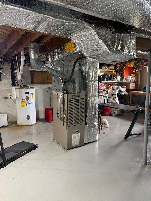 Completed annual Platinum Level maintenance on a single HVAC system aged 10-12 years. Performed comprehensive inspection of furnace unit located in basement mechanical room, checked all operational components, replaced 16x25x1 air filter, inspected ductwork and connections, and verified proper system functionality. Documented equipment condition with photographic records of exterior condensing unit and interior furnace installation.