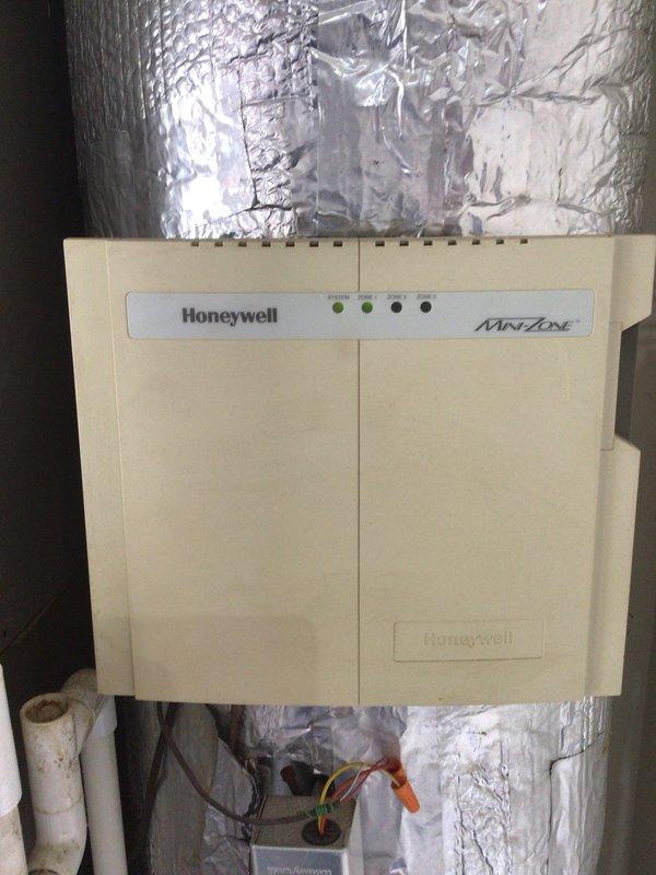 Completed scheduled AC tune-up maintenance on a 12-year-old air conditioning system with a 2018 condenser model. Performed standard preventive maintenance procedures, inspected Honeywell MiniZone control unit with operational LED indicators and associated ductwork connections, and verified Navien NPE-180A instantaneous water heater installation. Replaced 20x25x4 polarized air filter and confirmed all system components functioning properly with no immediate service needs identified.