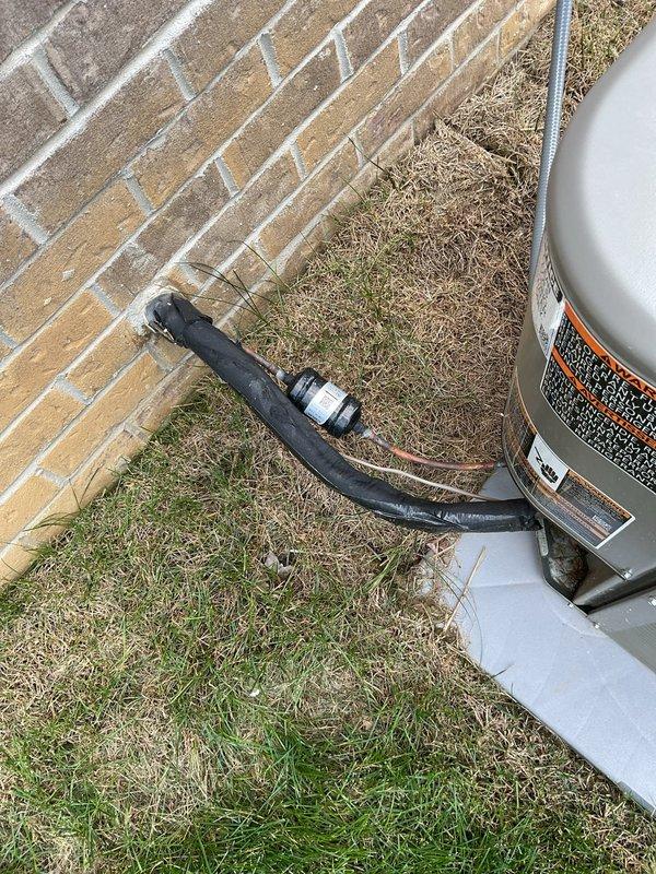 Responded to no cooling complaint on 7-month-old system blowing room temperature air with 12-degree temperature differential between setpoint and actual room temperature. Performed diagnostic evaluation of recently installed HVAC system including inspection of outdoor condensing unit, indoor air handler, refrigerant lines, and electrical connections. Verified proper airflow through vents with no ice buildup present at indoor coil, confirmed system operational status, and documented installation configuration with outdoor unit on concrete pad and indoor equipment in mechanical closet with standard PVC condensate drainage.