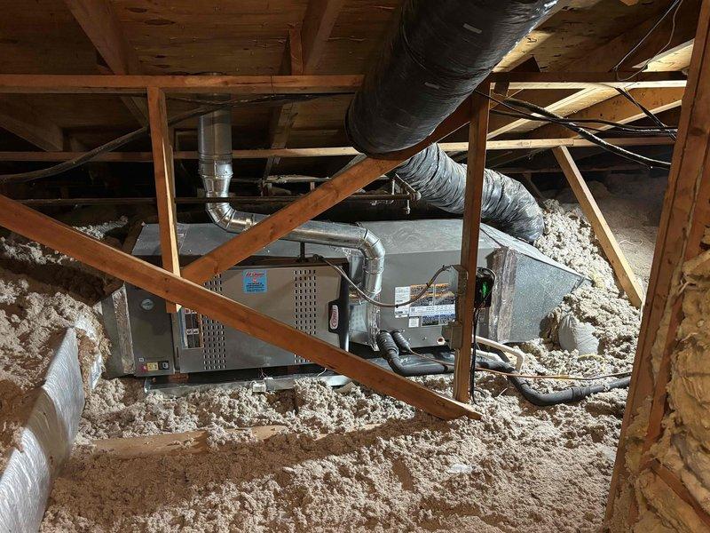 Completed installation of a 4-ton, 17 SEER split system with 80% AFUE upflow furnace in residential attic space. Mounted air handler unit on attic floor with proper clearances and secured all ductwork connections. Installed new control board with proper wiring connections including power, thermostat, and safety circuits using color-coded wiring to terminal blocks. Routed flexible ductwork throughout attic space to supply registers, ensuring proper support and insulation wrap on all duct runs. Verified all electrical connections at control board, tested system operation, and confirmed proper airflow through distribution system.