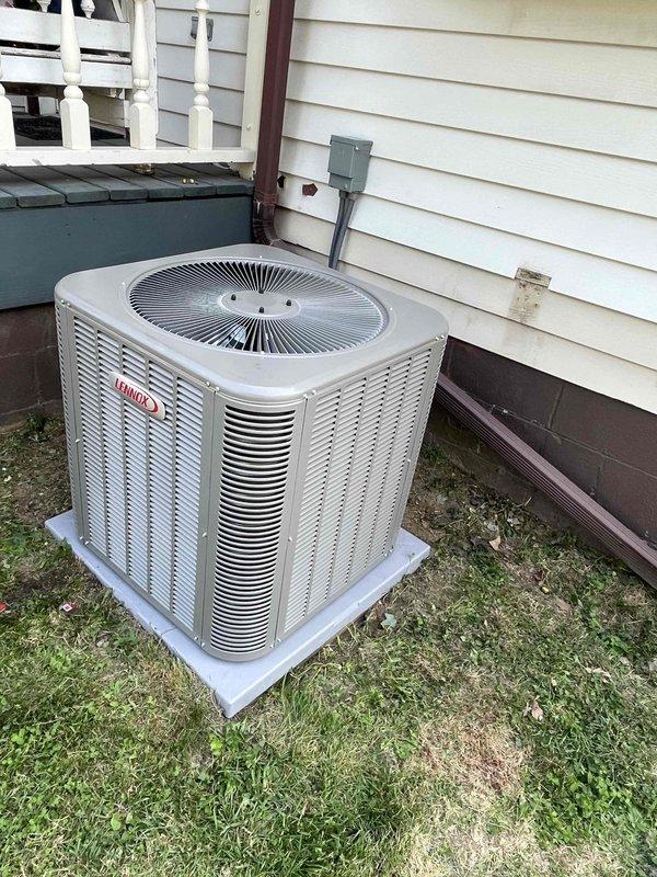 Completed installation of 2.5-ton Lennox air conditioning system with matching evaporator coil at residential property. Unit was positioned on concrete pad adjacent to structure with proper clearances maintained, electrical disconnect installed per code requirements, and refrigerant lines connected and charged to manufacturer specifications. System startup performed with diagnostic readings confirming proper operation at 92.1°F condensing temperature and 324 VAC supply voltage.