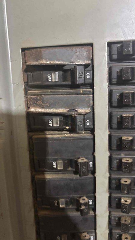 Completed comprehensive HVAC replacement estimate for 30-year-old upstairs system. Documented existing electrical infrastructure showing extensive corrosion and rust on circuit breaker panel, bus bars, and mounting hardware, indicating prolonged exposure to moisture and age-related deterioration. Assessed electrical disconnect and main breaker panel condition to determine compatibility requirements and necessary electrical upgrades for new system installation.