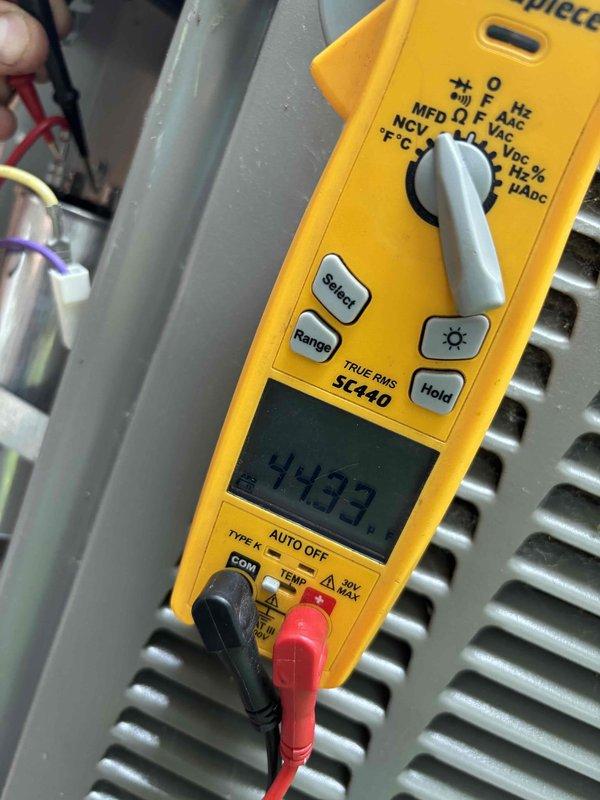 Completed annual planned maintenance service on a one-year-old HVAC system. Upon inspection, discovered significant ice buildup on the evaporator coil with temperatures reading 53°F, indicating a critical cooling system malfunction. Performed electrical diagnostics using a true RMS multimeter, recording a measurement of 4433, and documented the extensive frost formation throughout the air handler cabinet. Replaced the 20x20x5 filter and processed contract renewal as this was the second visit of the service agreement.