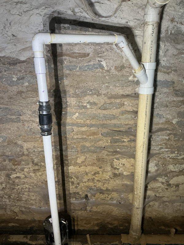 Responded to a main drain backup causing sump pump bubbling and water accumulation in the basement. Located the main cleanout approximately 10 feet from the affected area on the exterior wall and performed a complete drain cleanout to restore proper flow to the municipal sewer system. Successfully cleared the blockage, eliminating the backup condition and restoring normal drainage function throughout the system.