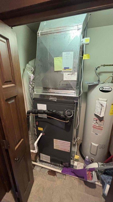 Conducted comprehensive HVAC system replacement estimate for residential property where existing system failed to turn on. Evaluated outdoor condensing unit positioned against brick exterior and indoor air handler/furnace configuration located in basement utility area. Assessed current equipment condition, ductwork connections, electrical service, and installation requirements to provide complete system replacement recommendations for non-operational heating and cooling system.