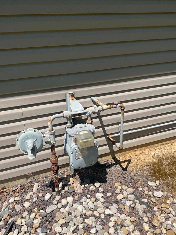 Conducted comprehensive replacement estimate for non-operational residential HVAC system. Evaluated existing Goodman forced air furnace (Model DGAA077BDTB, 77,000 BTUH input capacity) currently installed in utility closet, noting unit age and condition. Assessed natural gas supply infrastructure including exterior meter assembly, pressure regulator, and piping configuration to determine compatibility requirements for replacement equipment. Documented system specifications, clearances, and installation parameters. Photographed existing equipment and gas service connections for proposal development. Provided homeowner with complete replacement options and recommendations for new HVAC system installation.