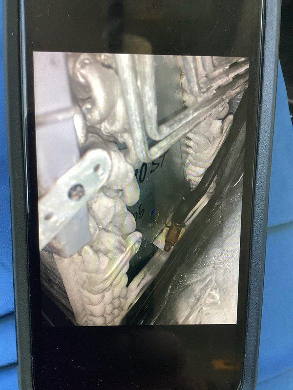 Responded to no cooling complaint on seven-year-old air conditioning system that had experienced frozen evaporator coil earlier in the morning. Upon arrival, allowed system to complete thaw cycle before conducting diagnostic evaluation. Inspected evaporator coil and refrigerant lines, documenting condition of copper linesets and heat exchanger components. System assessed and photographed for service records.