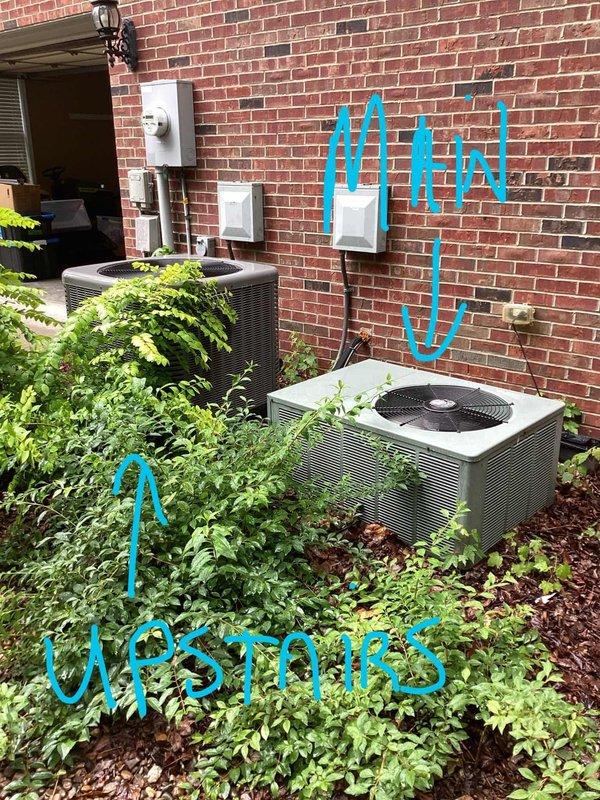 Responded to no-cooling complaint on upstairs HVAC system at residential property with dual condenser units. Upon arrival, confirmed 6-year-old system was not operating with no airflow at vents and no breakers tripped. Performed diagnostic evaluation of beige/tan condenser unit designated for upstairs zone, inspected electrical disconnect, refrigerant line connections, and verified system status against customer-reported symptoms of complete system failure.