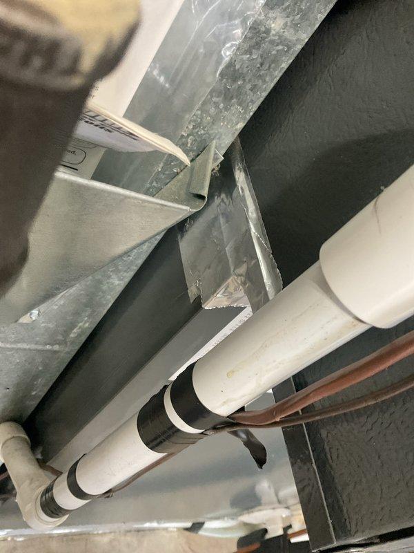 Responded to follow-up service call regarding incomplete planned maintenance from previous visit. Upon arrival, inspected HVAC ductwork in overhead space where previous technician had applied temporary sealant tape to seal duct opening. Found that foil tape had detached from duct chase opening, allowing conditioned air to escape into unconditioned garage space. Removed failed tape application and properly sealed rectangular duct opening with appropriate foil-faced tape, ensuring complete adhesion to all edges of the chase. Verified duct insulation integrity and confirmed no additional air leakage points in the overhead mechanical space. System now operating efficiently with conditioned air properly contained within the intended distribution system.