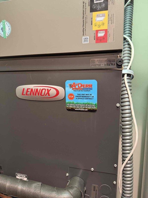 Completed installation of a 3-ton, 19 SEER Lennox heat pump system including outdoor condensing unit and indoor air handler. Outdoor unit was positioned on existing concrete pad against exterior stone wall with refrigerant lines properly routed and connected. Indoor air handler was installed with ductwork connections completed, filter access verified, and all electrical connections secured per manufacturer specifications.