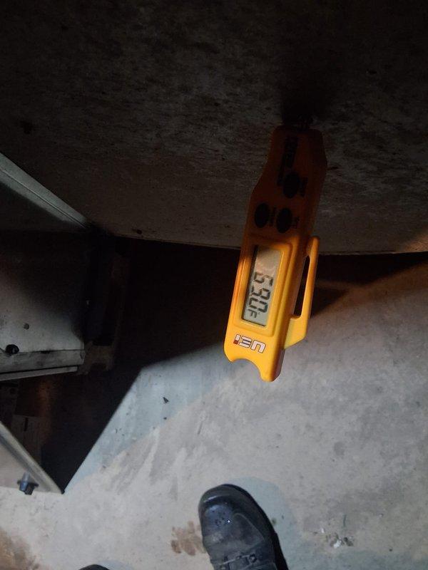 Responded to no heating or cooling call and found 20-year-old thermostat inoperative, preventing system operation. Evaluated outdoor condenser unit which showed signs of age and neglect with significant vegetation overgrowth restricting airflow and debris accumulation on top cover. Measured supply air temperature at 30.5°F, confirming system capability when powered. Diagnosed failed thermostat as primary issue preventing system calls for heating and cooling modes.