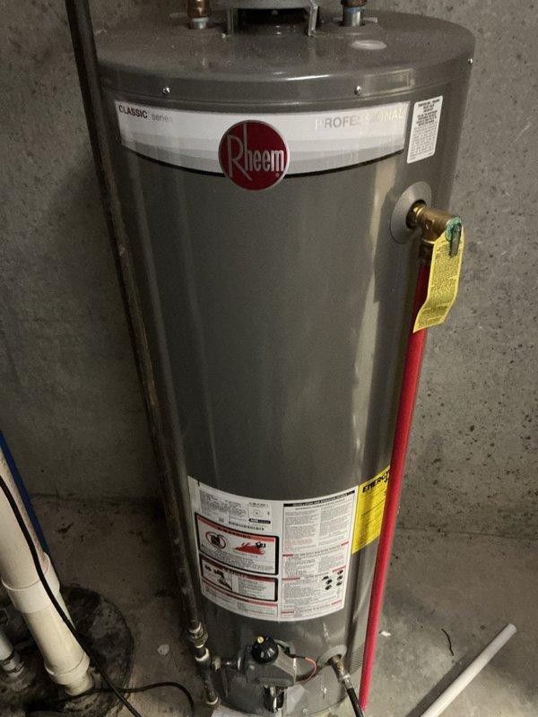 Completed Bronze membership water heater flush service on Rheem Classic Professional tanked unit. Drained sediment from tank bottom, verified proper operation of temperature and pressure relief valve with yellow tag, inspected all copper supply line connections and brass fittings for leaks, and confirmed unit returned to normal operation with no issues observed.
