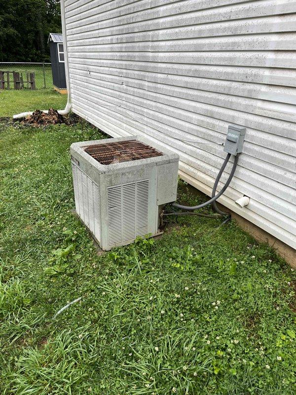 Completed comprehensive HVAC replacement estimate for 850 square foot residence requiring 2-ton, 14 SEER air conditioning system with 95-96 AFUE upflow gas furnace and evaporator coil replacement. Inspected existing outdoor condenser unit with visible aging and wear on copper coil components, assessed crawl space conditions revealing moisture concerns and existing ductwork configuration. Documented current system specifications and spatial requirements to provide accurate equipment sizing and installation recommendations for complete system replacement.