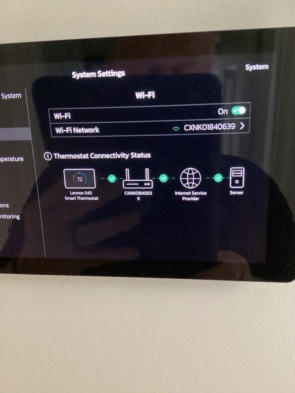 Completed annual platinum-level maintenance on single-system residential HVAC unit installed in February 2026. Performed comprehensive inspection of Lennox S40 smart thermostat, verified Wi-Fi connectivity to network CXNK0I840639 with confirmed communication to internet service provider and cloud servers. Inspected outdoor condenser unit positioned against exterior brick wall, documented equipment condition through photographic records. Collected filter size specifications for future service visits. All system components operating within normal parameters with smart thermostat displaying proper temperature control at 72 degrees. This represents the first scheduled maintenance visit for this installation with no renewal currently required.