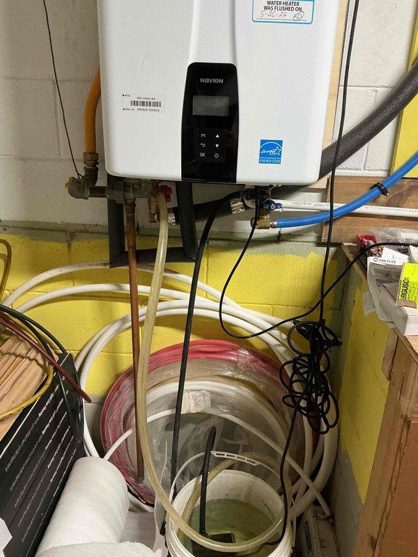 Performed scheduled maintenance flush on Navien tankless water heater per customer's requested appointment time. Completed descaling procedure using flush kit with cleaning solution to remove mineral buildup from heat exchanger, ensuring optimal unit performance and efficiency. Applied service sticker documenting maintenance completion date. Unit tested and operating within normal parameters upon service completion.