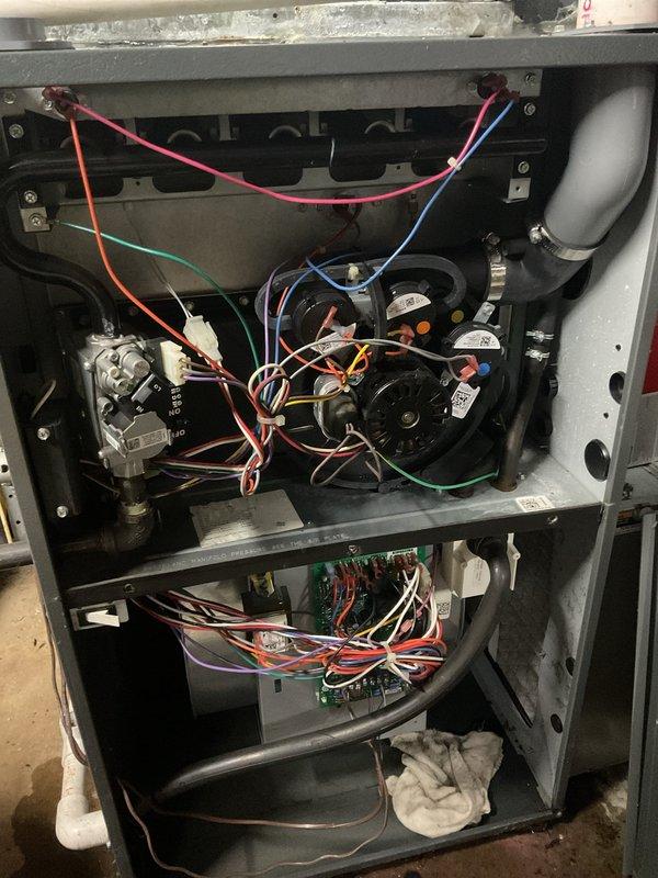 Completed scheduled HVAC maintenance on residential system. Performed comprehensive inspection of furnace and air conditioning components, including internal electrical connections, control boards, gas valve, blower assembly, and ductwork. Accessed and evaluated internal components with panels removed, verified proper wiring connections throughout multiple compartments, and inspected condensate drainage system including PVC piping for proper operation to address reported condensation concerns.