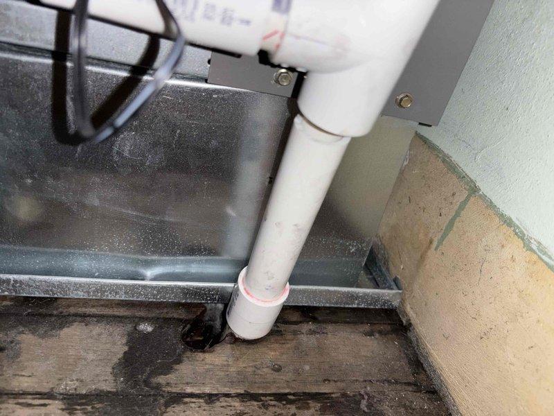 Responded to install callback for water leak at furnace location. Upon arrival, found evidence of water damage on floor near condensate drain assembly. Repaired separated PVC drain connection using appropriate adhesive and restored proper drainage function. Replaced air filter with temporary 1-inch filter as immediate solution. System tested and confirmed operational with no active leaking present.