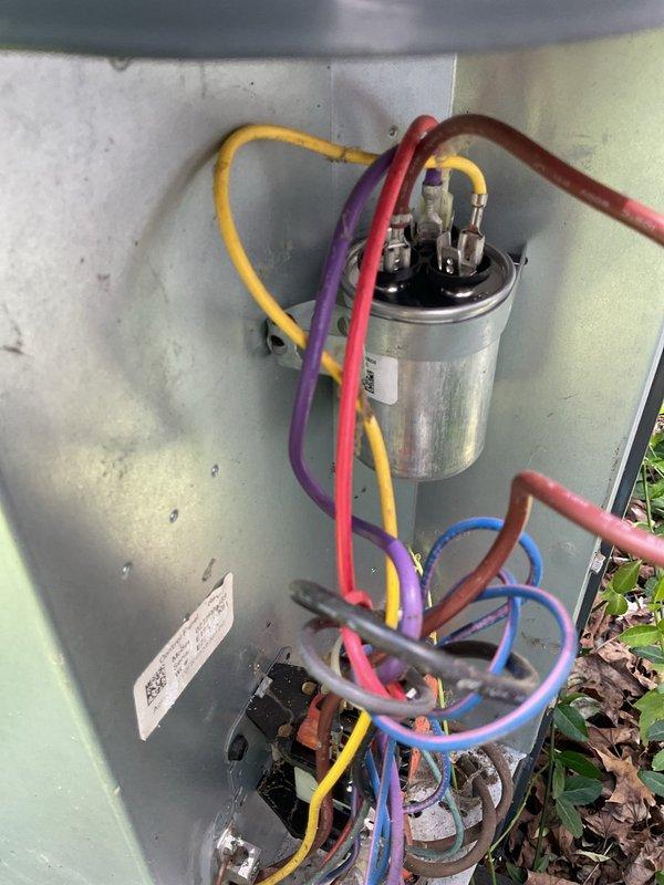 Responded to no cooling complaint on 6-year-old residential air conditioning system with adequate airflow but insufficient cooling. Upon inspection of outdoor condensing unit, diagnosed failed dual-run capacitor preventing compressor from operating properly. Replaced defective capacitor with OEM-equivalent component, verified proper voltage and amperage readings, and tested system operation. Unit now cooling effectively with compressor and condenser fan motor running within manufacturer specifications. Performed complete maintenance service including coil cleaning, refrigerant charge verification, and electrical connection inspection. Advised property owner to maintain clearance around outdoor unit due to excessive vegetation growth observed during service.