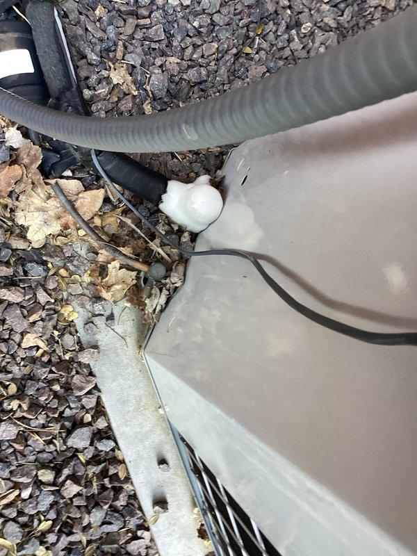 Responded to no-cooling complaint on 17-year-old residential air conditioning system. Upon arrival, found outdoor condensing unit inoperative with reported history of loud noise prior to failure. Indoor evaporator coil inspection revealed severe frost and ice accumulation on refrigerant lines and coil surfaces, indicating restricted airflow or refrigerant system malfunction. Outdoor unit showed signs of age with debris accumulation around base. Documented frozen evaporator coil condition and exterior unit status with photographic evidence. Advised system shutdown to allow complete defrost of indoor coil before further diagnostic work could be performed. Given the age of the equipment and severity of the failure, recommended comprehensive system evaluation once defrost is complete to determine root cause and feasibility of repair versus replacement options.