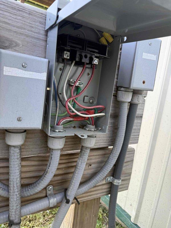 Responded to service call for pool pump switch estimate. Upon arrival, inspected existing outdoor electrical installation consisting of multiple junction boxes and disconnect mounted on exterior wall with associated conduit runs. Documented current configuration of electrical service setup including open disconnect box revealing internal wiring connections with multiple circuit conductors. Provided estimate for installation of flip switch control for pool pump operation based on existing electrical infrastructure and equipment accessibility.