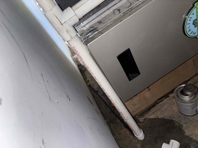 Responded to emergency water leak in basement affecting HVAC system. Upon arrival, found active water discharge from condensate drain line with significant water accumulation throughout basement area. Installed P-trap on condensate drain line to resolve leak and ensure proper drainage function. Performed routine maintenance on two-year-old system including replacement of 20x26x5 carbon filter. Verified all drain connections secured and system operating properly with no further water discharge. Documented equipment condition and installation with photographs.