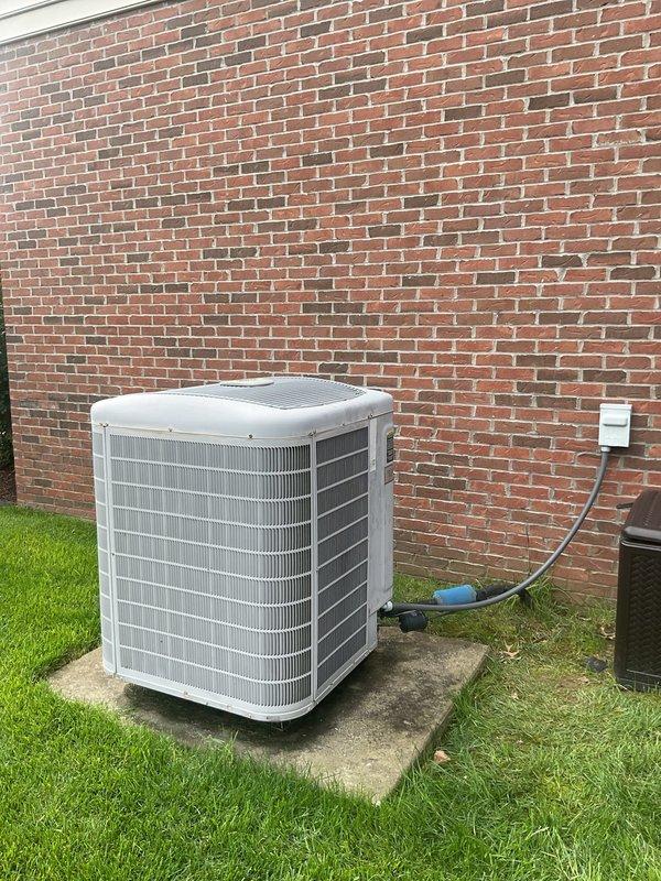 Conducted HVAC system replacement estimate at residential property. Documented existing outdoor condensing unit positioned on concrete pad adjacent to brick exterior wall, along with electrical service panel and disconnect configuration. Photographed current equipment specifications, electrical infrastructure, and installation conditions to provide comprehensive assessment for complete system replacement recommendation.
