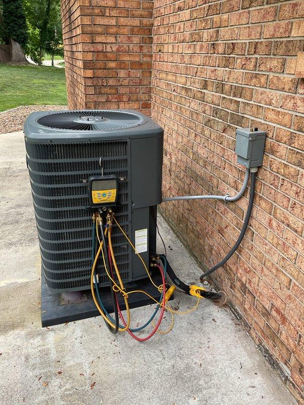 Responded to no cooling complaint on 4-6 year old residential air conditioning system blowing warm air. Upon arrival, confirmed adequate airflow at supply registers with no ice formation on indoor coil. Connected refrigerant manifold gauges to outdoor condensing unit and performed system pressure diagnostics. Measured suction pressure at 170.8 PSI and discharge pressure at 267.3 PSI, indicating abnormal operating conditions. Temperature readings confirmed insufficient cooling capacity and improper refrigerant charge affecting system performance. Identified refrigerant-related issue preventing proper heat transfer and cooling output, requiring corrective action to restore normal system operation.