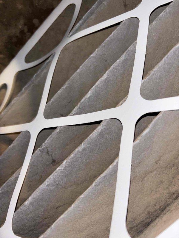 Responded to return visit for complete loss of cooling on less-than-one-year-old system with no ice buildup observed. Upon inspection, found dirty air filter restricting airflow, as evidenced by condensation on unit cabinet and heavily loaded filter media. Replaced air filter and verified proper system operation, restoring cooling to entire home.