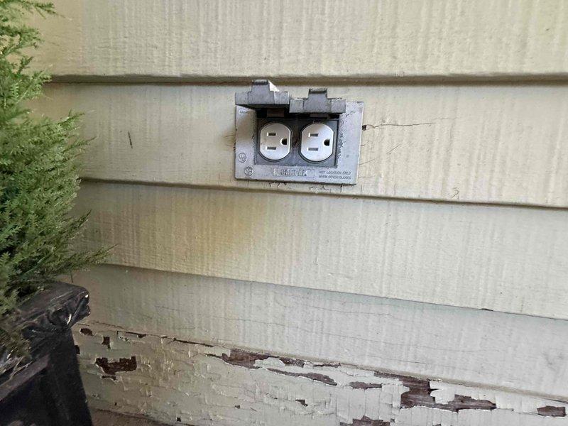 Responded to service call for multiple electrical issues including non-functioning garage lighting, loose or inoperative outlets, and a failing bathroom exhaust fan. Inspected exterior weatherproof outlet mounted on vinyl siding and evaluated ceiling-mounted bathroom ventilation fixture with integrated lighting. Diagnosed electrical connectivity problems at receptacle locations and assessed ventilation fan motor performance to determine repair requirements.