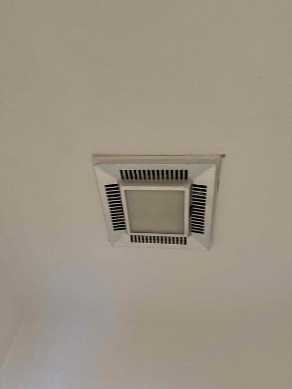 Responded to service call for multiple electrical issues including non-functioning garage lighting, loose or inoperative outlets, and a failing bathroom exhaust fan. Inspected exterior weatherproof outlet mounted on vinyl siding and evaluated ceiling-mounted bathroom ventilation fixture with integrated lighting. Diagnosed electrical connectivity problems at receptacle locations and assessed ventilation fan motor performance to determine repair requirements.