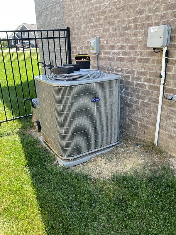 Responded to no-cool complaint on 6-year-old Carrier system with weak airflow to upstairs zone and excessive noise. Upon arrival, found thermostat displaying 75°F with setpoint at 70°F. Performed complete system diagnostics on indoor air handler and outdoor condensing unit. Inspected blower motor assembly and found reduced airflow due to restricted air filter and debris accumulation on evaporator coil. Replaced dirty air filter and cleaned evaporator coil to restore proper airflow. Checked refrigerant charge and operating pressures—system within manufacturer specifications. Identified source of excessive noise as loose blower wheel assembly; tightened set screws and verified balanced operation. Tested system operation across all zones, confirmed adequate airflow at upstairs registers and proper temperature differential across coil. System cooling effectively and operating within normal sound levels at departure.