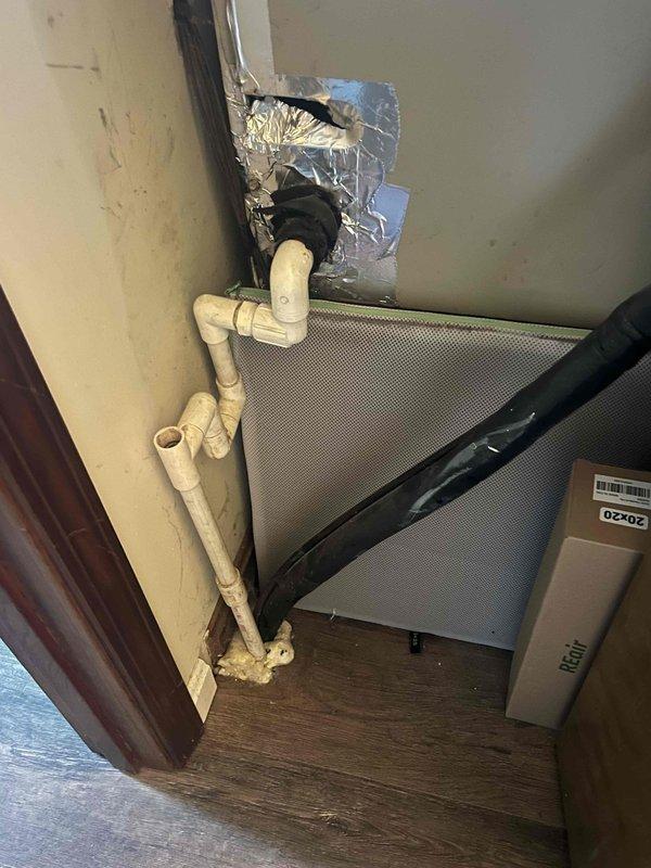 Conducted comprehensive HVAC replacement estimate for existing closet-installed system consisting of vertically-mounted air handler and furnace units. Evaluated current equipment configuration, assessed PVC condensate drainage routing along wall with multiple elbow connections, and documented deteriorated ductwork sealing with failing foil tape and exposed insulation at ceiling penetration. Provided whole home upgrade proposal including replacement heating and cooling system with complimentary water heater installation per promotional offer.