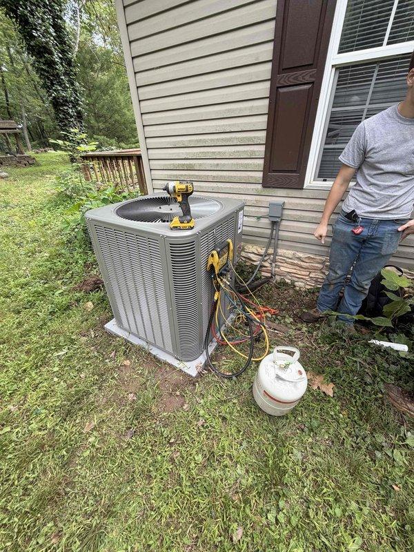 Completed installation of a 3.5-ton, 15.5 SEER heat pump system with matching air handler in a modular home in Boonville. The outdoor heat pump unit was positioned on a concrete pad adjacent to the home's exterior wall with proper clearances maintained, and refrigerant lines were connected and charged to manufacturer specifications. The indoor air handler was installed vertically in a dedicated utility closet with appropriate supply and return air ductwork connections to the existing plenum system.