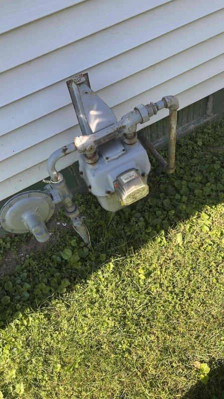 Completed HVAC system replacement estimate for a 31-year-old residential unit that has been in service since original home construction. The existing system utilizes R-22 refrigerant, which was phased out of production in 2010, making future service and repairs increasingly difficult and costly. Documented existing gas meter installation and exterior connections, photographed current system configuration including furnace, evaporator coil, and base assembly with detailed measurements for proper replacement sizing. Assessed installation space requirements and clearances, noting return air and plenum-to-ceiling height dimensions to ensure proper fitment of new equipment. Discussed system replacement options with homeowner, who is exploring potential coverage through homeowners insurance. Customer was referred through previous professional connection and will coordinate with family member for final installation scheduling once financing and insurance options are confirmed.