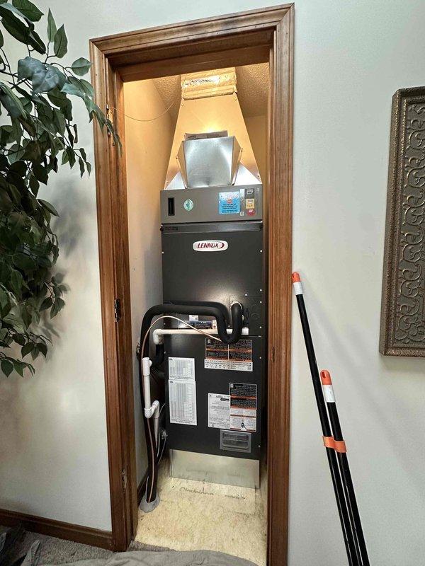 Completed installation of a 3-ton, 19 SEER Lennox heat pump system at residential property. Indoor air handler unit was installed in utility closet with proper clearances and ductwork connections, while outdoor condenser unit was positioned on concrete pad against exterior wall with appropriate refrigerant line routing and electrical disconnect. All components were secured, tested for proper operation, and system was commissioned per manufacturer specifications.