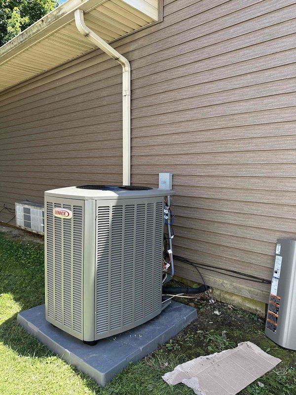 Completed installation of a 3-ton, 19 SEER Lennox heat pump system at residential property. Indoor air handler unit was installed in utility closet with proper clearances and ductwork connections, while outdoor condenser unit was positioned on concrete pad against exterior wall with appropriate refrigerant line routing and electrical disconnect. All components were secured, tested for proper operation, and system was commissioned per manufacturer specifications.