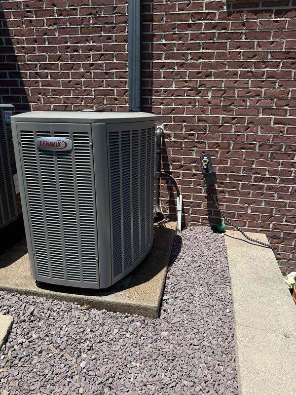 Completed installation of a 2-ton, 19 SEER Lennox heat pump system with matching air handler. System was properly mounted on concrete pad with gravel landscaping, refrigerant lines installed and insulated, electrical disconnect wired, and unit evacuated and charged to manufacturer specifications as verified with digital manifold gauges.