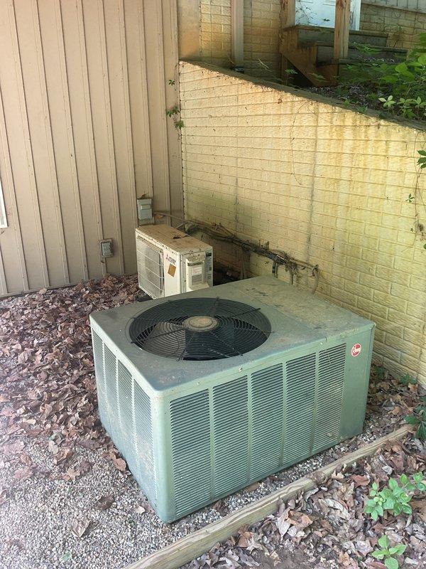 Conducted comprehensive replacement estimate for aging HVAC system over 20 years old that is no longer operational. Evaluated existing outdoor condenser unit with green cabinet and indoor furnace/air handler with extensive copper piping network showing significant age and oxidation. Assessed complete system replacement requirements including outdoor condensing unit, indoor air handling equipment, refrigerant line sets, electrical disconnects, and existing ductwork connections to provide homeowner with full replacement options and specifications.