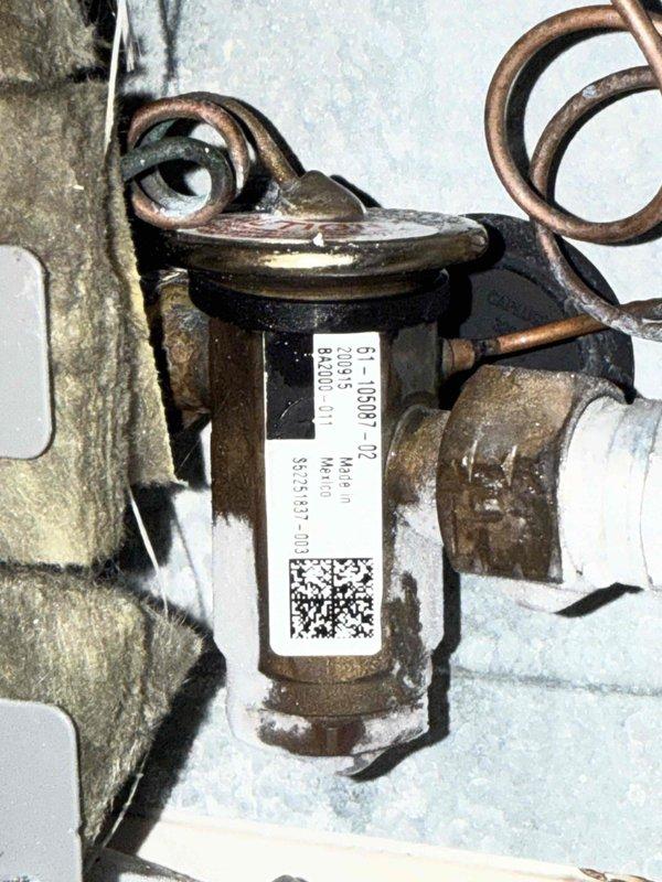 Responded to no-cool complaint on 5-year-old system in commercial facility where water sensor had activated and unit was not maintaining thermostat setpoint. Diagnosed system and identified TXV valve showing signs of age and potential refrigerant flow restriction based on visual inspection of component and operational parameters. Performed maintenance inspection on secondary HVAC system to ensure both units were operating efficiently, documented findings with photographic evidence of affected components and overall system configuration for warranty processing and follow-up repair scheduling.