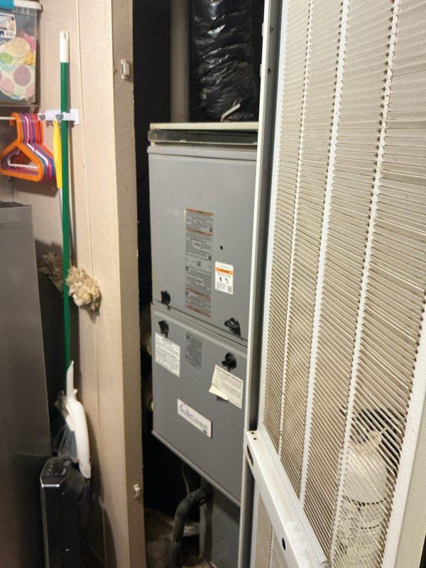Responded to no cooling complaint on 6-year-old residential HVAC system running continuously but delivering warm air with thermostat set to 72°F and reading 74°F. Performed diagnostic evaluation of indoor air handler unit and associated components. Inspected electrical connections, circuit breakers, and control systems with no tripped breakers identified. Examined refrigerant lines, coil condition, and ductwork connections. Verified airflow through supply vents and confirmed no ice accumulation on evaporator coil or furnace components. Documented system installation configuration including air handler placement, return air plenum, and flexible ductwork routing in utility closet. Assessed overall system operation and identified cooling system malfunction preventing proper temperature control.