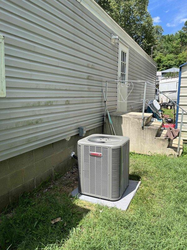 Completed full installation of a 2-ton, 14.7 SEER Coleman split system including outdoor condensing unit and indoor modular air handler. The outdoor unit was positioned on a concrete pad adjacent to the building exterior with proper clearances maintained, refrigerant lines and electrical conduit professionally routed along the structure, and all connections secured per manufacturer specifications. The indoor air handler was wall-mounted in the living space with integrated return air grill and control panel, providing efficient climate control for the residence. System was fully charged, tested for proper operation, and left in excellent working condition.