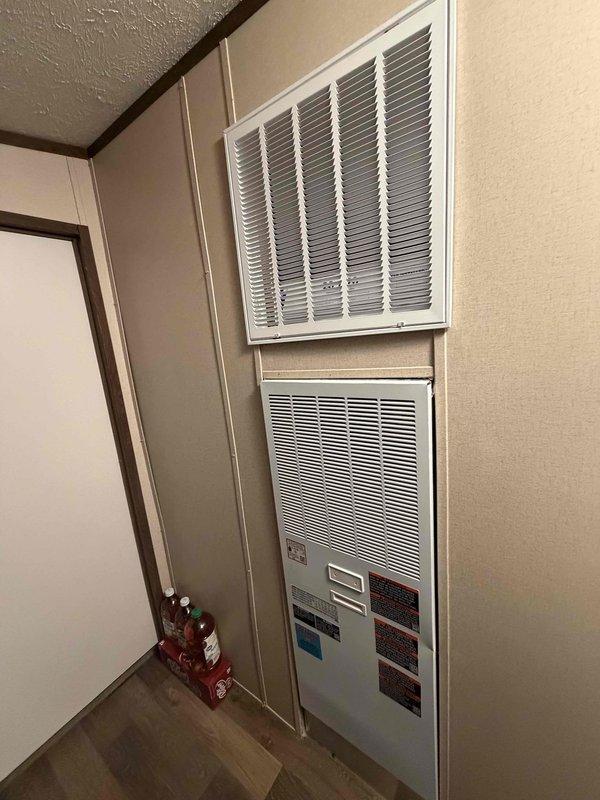 Completed full installation of a 2-ton, 14.7 SEER Coleman split system including outdoor condensing unit and indoor modular air handler. The outdoor unit was positioned on a concrete pad adjacent to the building exterior with proper clearances maintained, refrigerant lines and electrical conduit professionally routed along the structure, and all connections secured per manufacturer specifications. The indoor air handler was wall-mounted in the living space with integrated return air grill and control panel, providing efficient climate control for the residence. System was fully charged, tested for proper operation, and left in excellent working condition.
