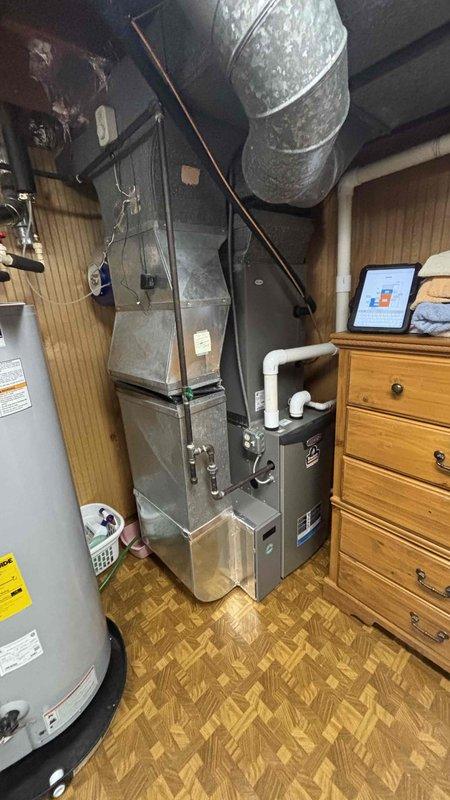 Completed comprehensive replacement estimate for 13-year-old HVAC system with existing functional equipment. Assessed current upflow furnace installation in basement utility area, documented existing ductwork configuration including flexible supply runs, measured plenum and coil dimensions for proper replacement sizing, and evaluated structural components including base condition and clearance requirements. Provided replacement options to former customer with detailed system specifications and installation requirements.