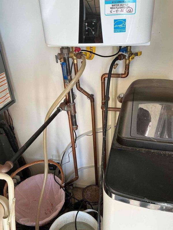 Performed USA Bronze preventive maintenance service on Navien tankless water heater unit. Completed full system flush procedure to remove mineral buildup and scale deposits from heat exchanger, descaled internal components using appropriate cleaning solution, and verified proper operation of all valves and connections. Unit tested and confirmed operating within manufacturer specifications upon completion of maintenance service.
