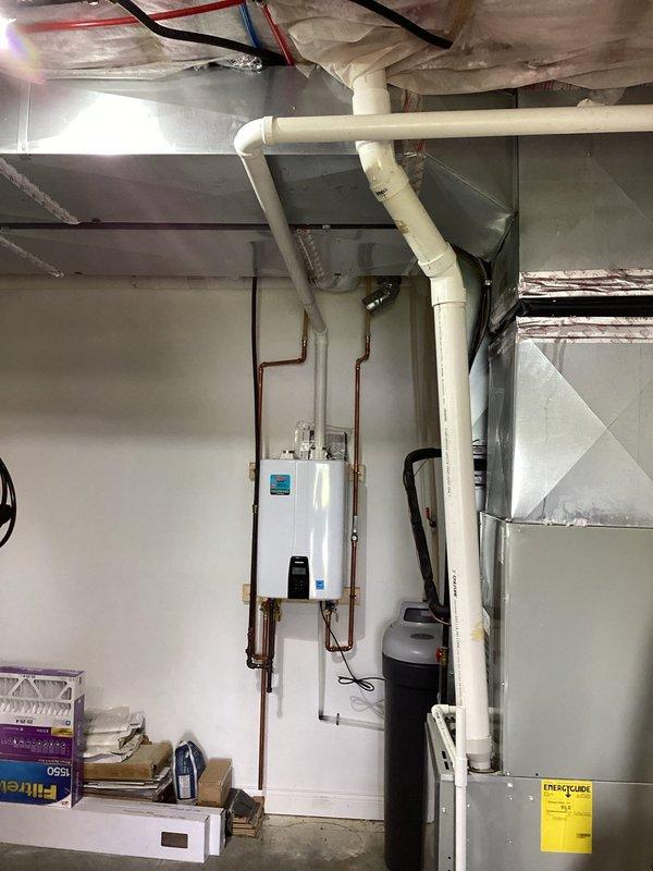 Installed NPE-210A tankless water heater in basement utility room, mounting unit to wall and connecting with copper supply piping. Completed all necessary venting with PVC exhaust system, integrated electrical connections, and ensured proper clearances from existing HVAC equipment and water softener system. All installations performed to manufacturer specifications and local code requirements.