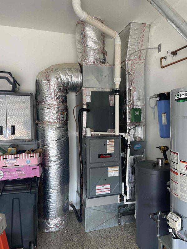 Responded to warranty service call and follow-up request for residential HVAC system located in garage utility area. Performed diagnostic inspection of furnace unit and identified failed evaporator coil requiring replacement. Documented model and serial number information, captured photographs of coil assembly and system configuration for parts ordering. System currently non-operational (red priority status). Estimated half-day installation time required upon part arrival.
